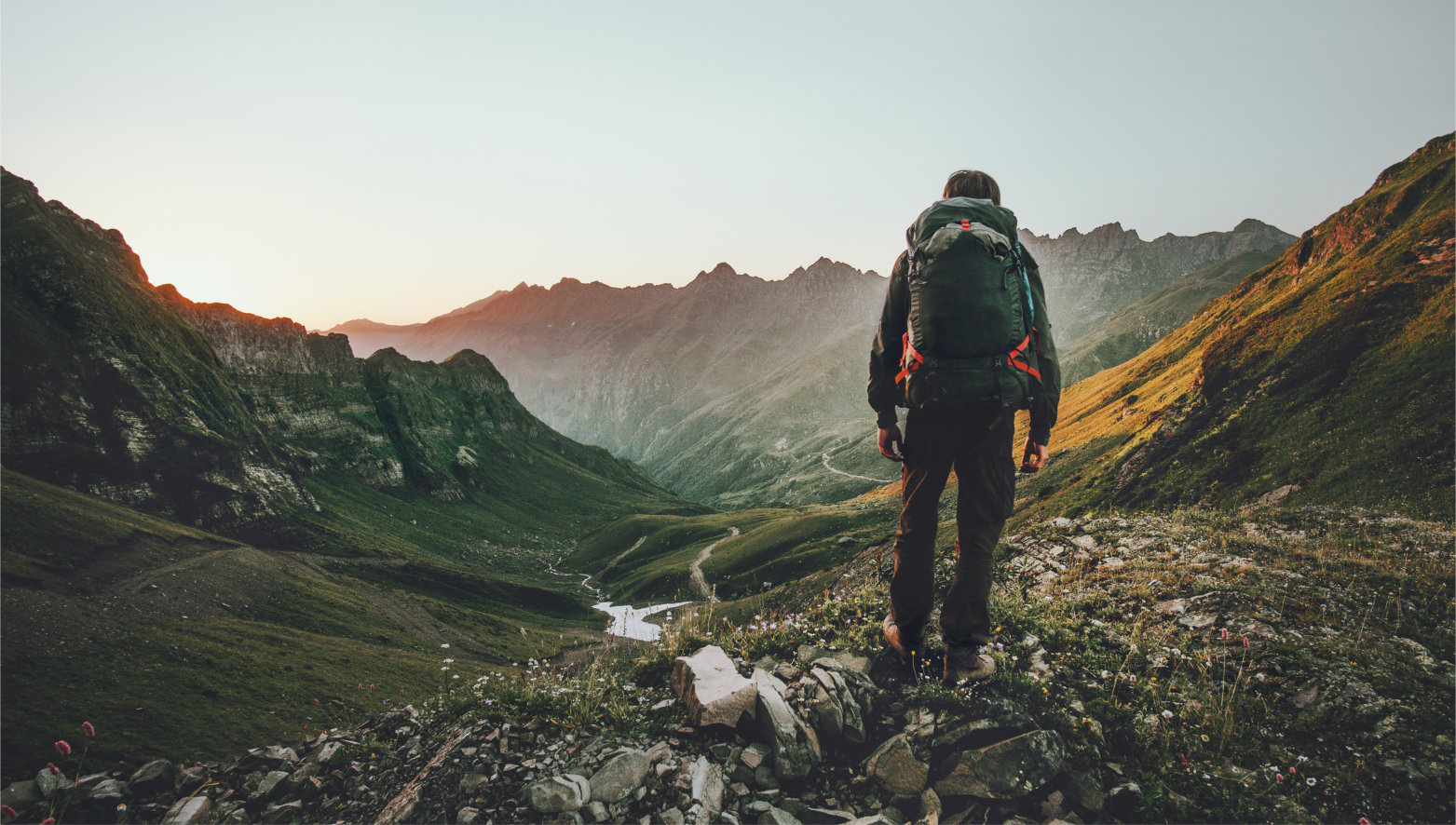 Man,Hiking,At,Sunset,Mountains,With,Heavy,Backpack,Travel,Lifestyle